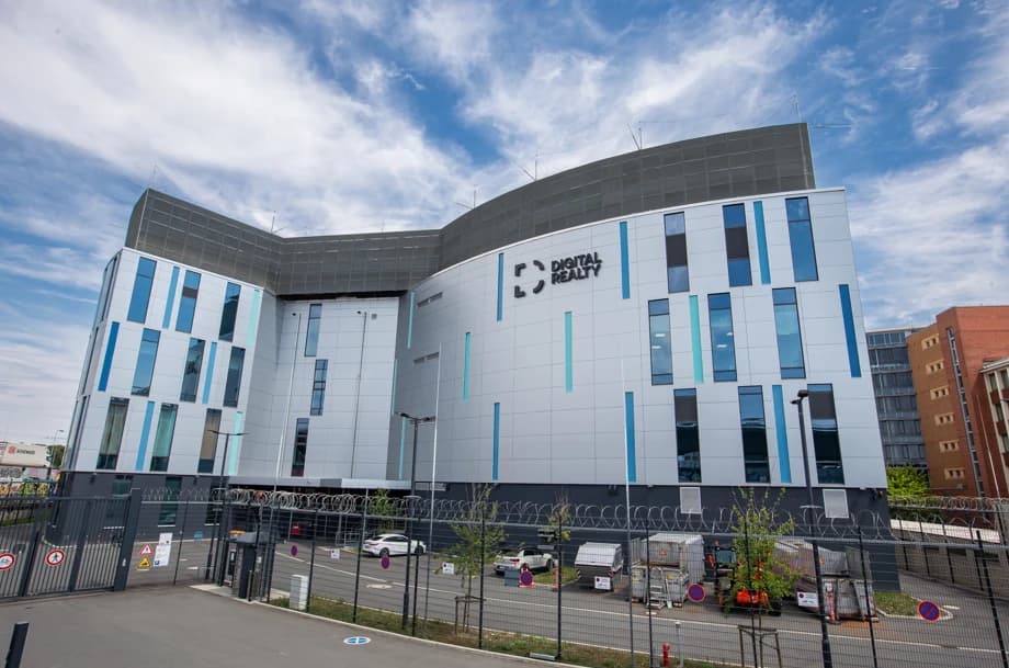 Digital Realty building with a white and blue facade and fenced forecourt